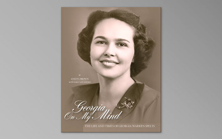 Photo of the book cover of a Family history book. A paperback binding with a printed and laminated image.